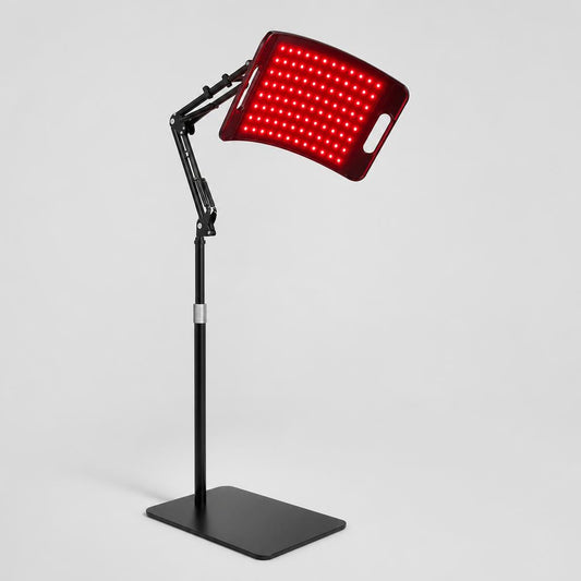 Lumora red light therapy panel glowing on its adjustable stand